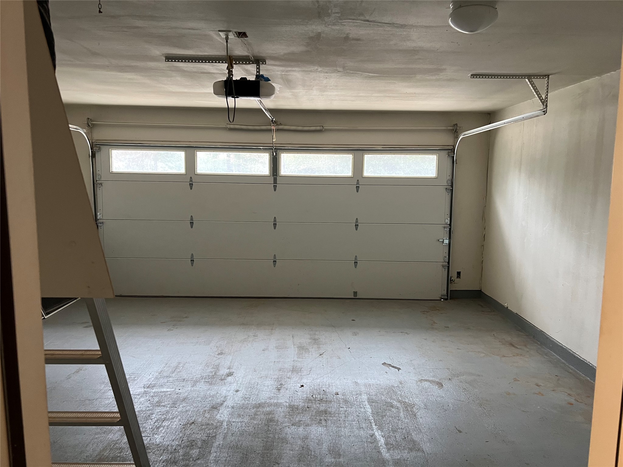 239 Old Firetower Road Bastrop, TX 78602 - Photo 11 of 39 Garage featuring a garage door opener