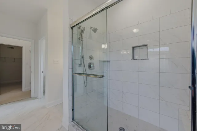 a bathroom with a shower and a glass door