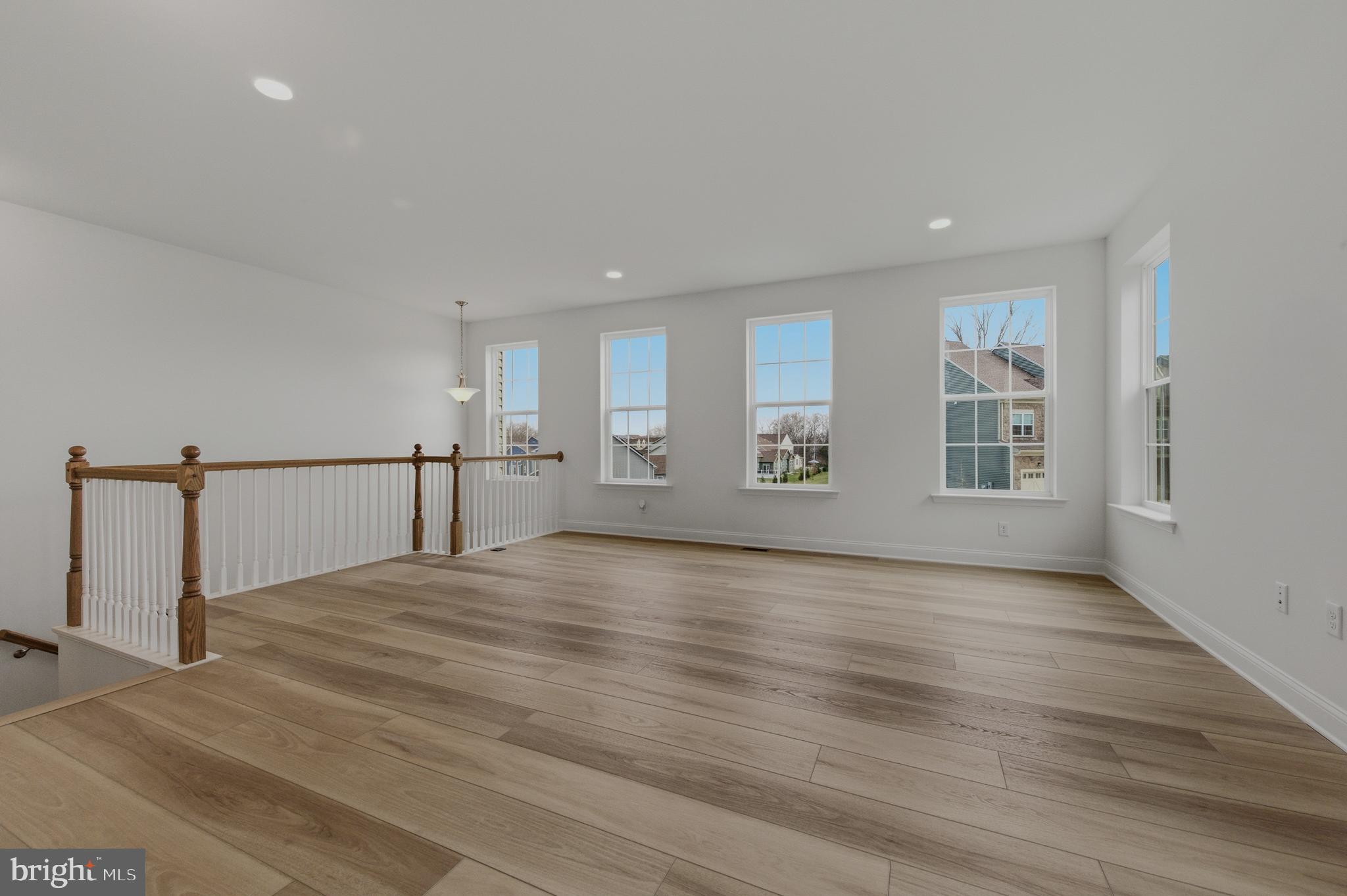 253 Grove View Drive Hockessin, DE 19707 - Photo 2 of 25 a view of an empty room with window and wooden floor