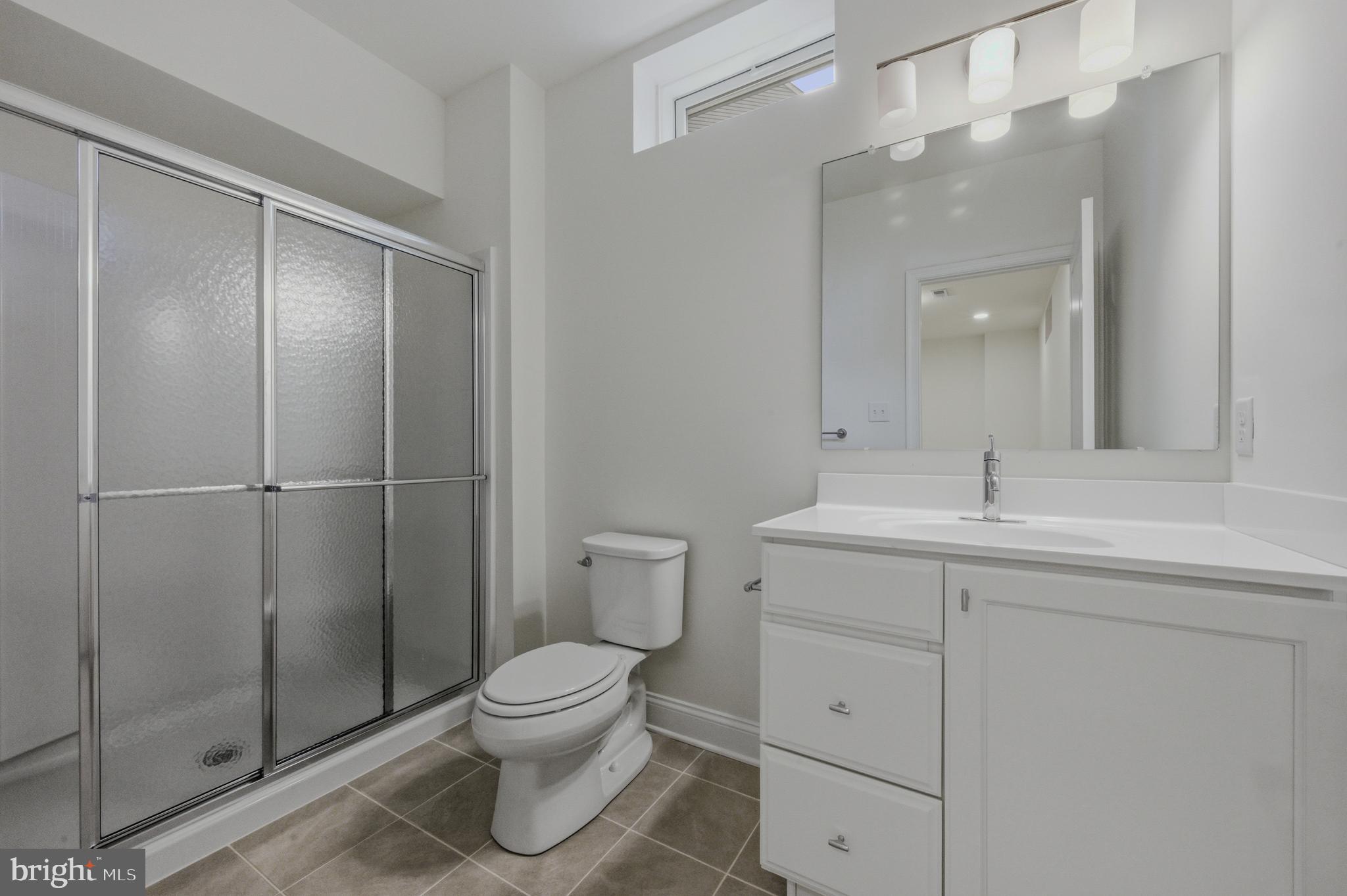253 Grove View Drive Hockessin, DE 19707 - Photo 21 of 25 a bathroom with a toilet sink and shower