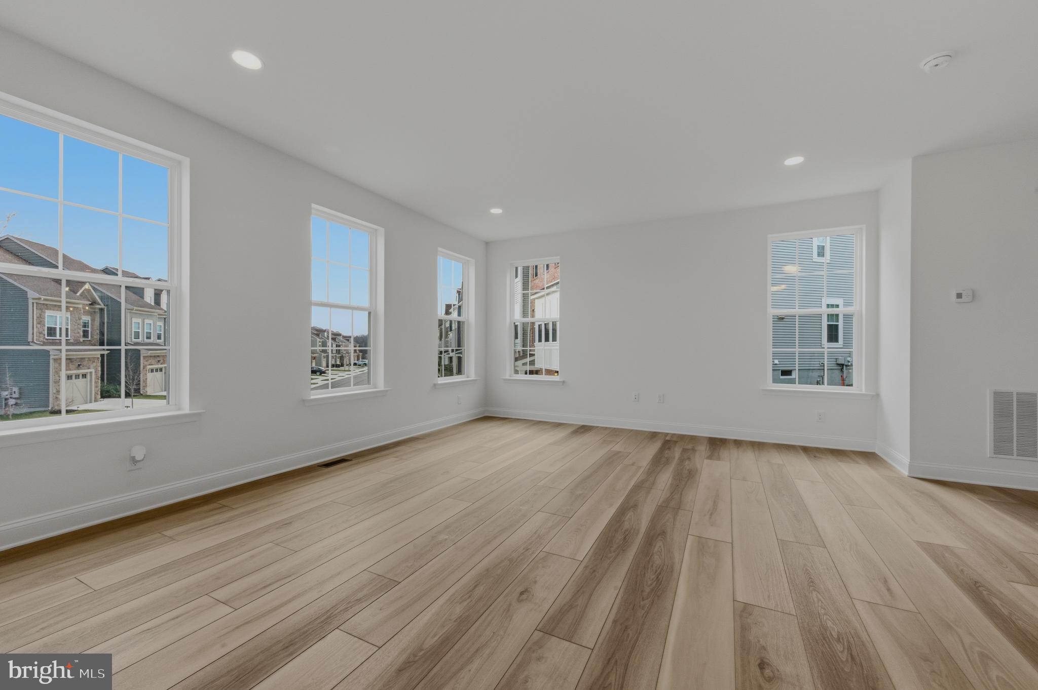 253 Grove View Drive Hockessin, DE 19707 - Photo 3 of 25 a view of an empty room with wooden floor and a window