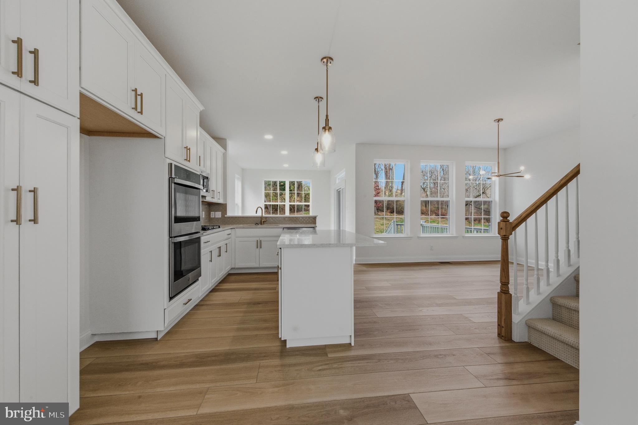 253 Grove View Drive Hockessin, DE 19707 - Photo 6 of 25 a view of a kitchen with wooden floor and a kitchen