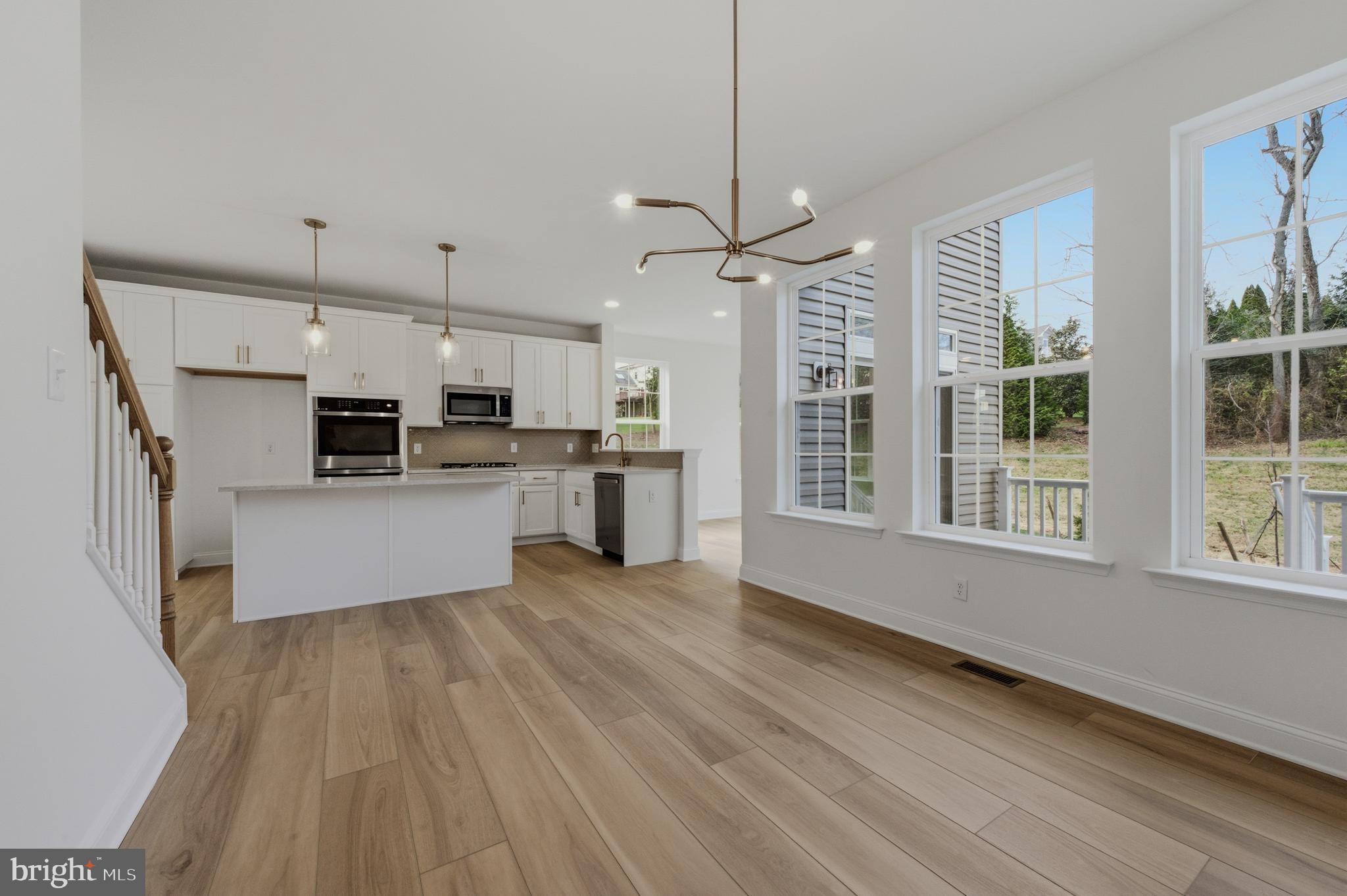 253 Grove View Drive Hockessin, DE 19707 - Photo 9 of 25 a large kitchen with cabinets wooden floor and stainless steel appliances