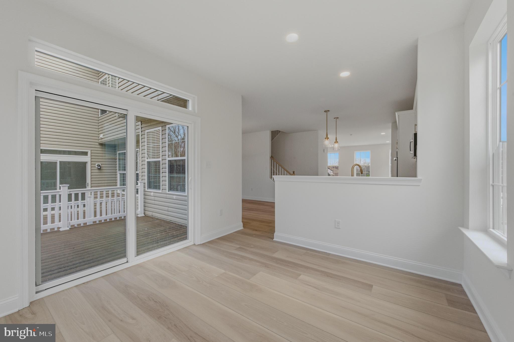 253 Grove View Drive Hockessin, DE 19707 - Photo 10 of 25 a view of a kitchen with wooden floor and windows