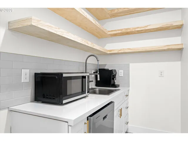 a view of a kitchen with furniture and a ceiling fan
