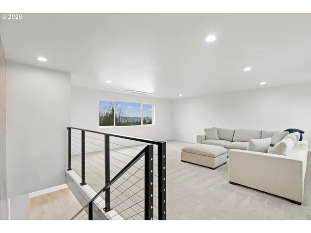 a living room with furniture a window and a flat screen tv