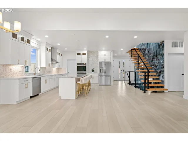 a kitchen with a table chairs microwave and cabinets