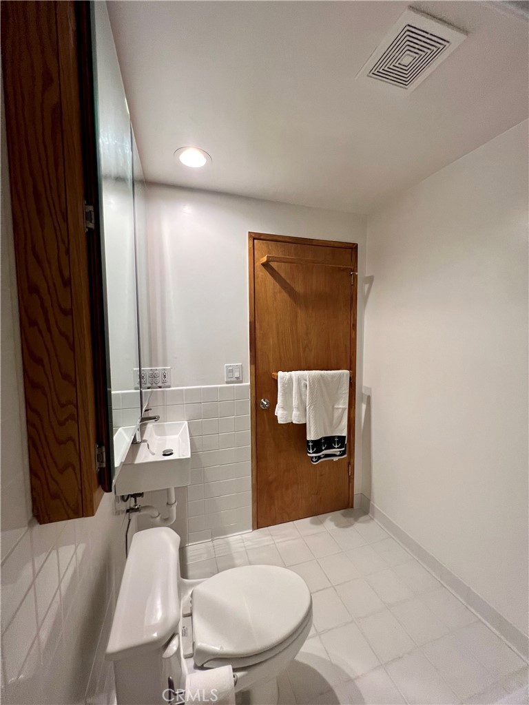 12 Coach Road Rancho Palos Verdes, CA 90275 - Photo 11 of 26 a bathroom with a toilet mirror and vanity