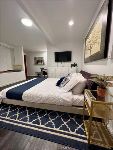 a bedroom with a bed and a flat screen tv