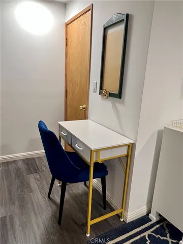 a view of a room with furniture and wooden floor