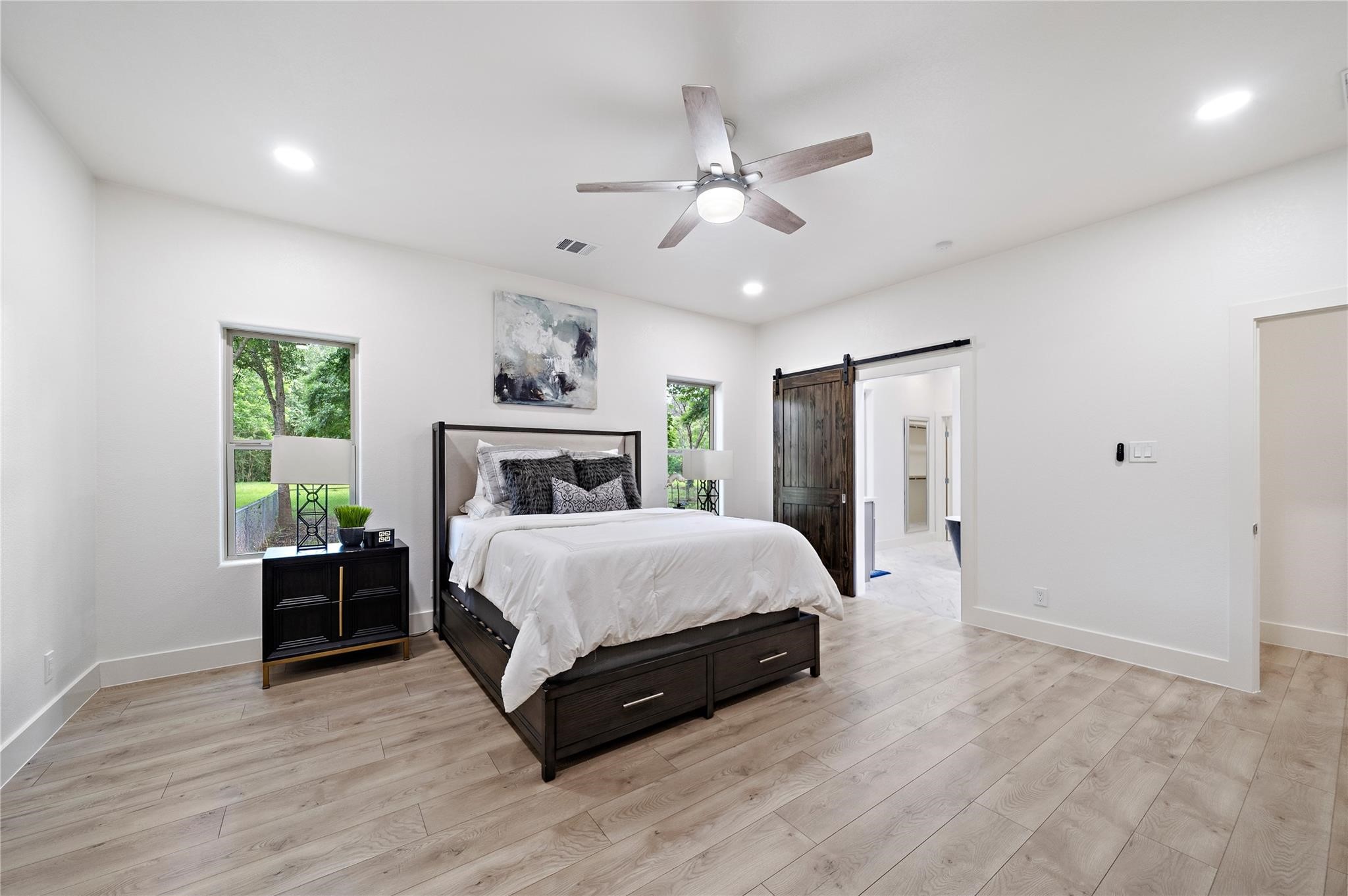 459 Live Oak Road Wharton, TX 77488 - Photo 11 of 27 a spacious bedroom with a large bed and a chandelier