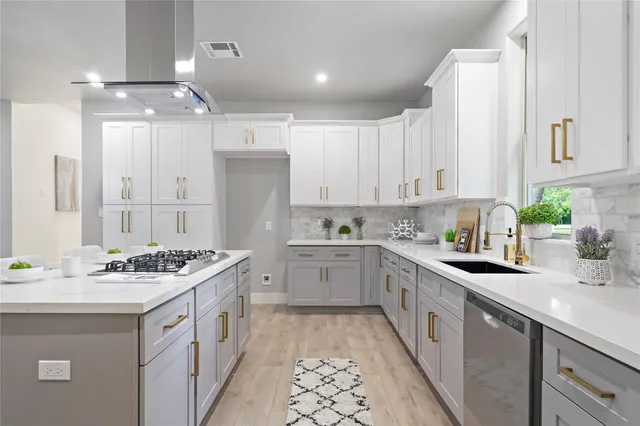 a kitchen with a sink stove cabinets and white wooden floor