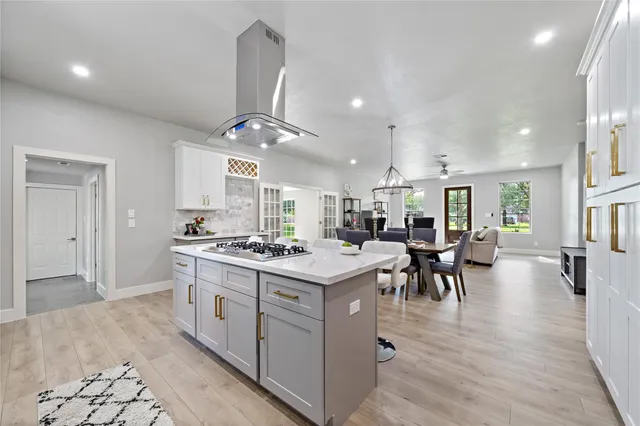 a kitchen that has a lot of cabinets a sink and a stove in it