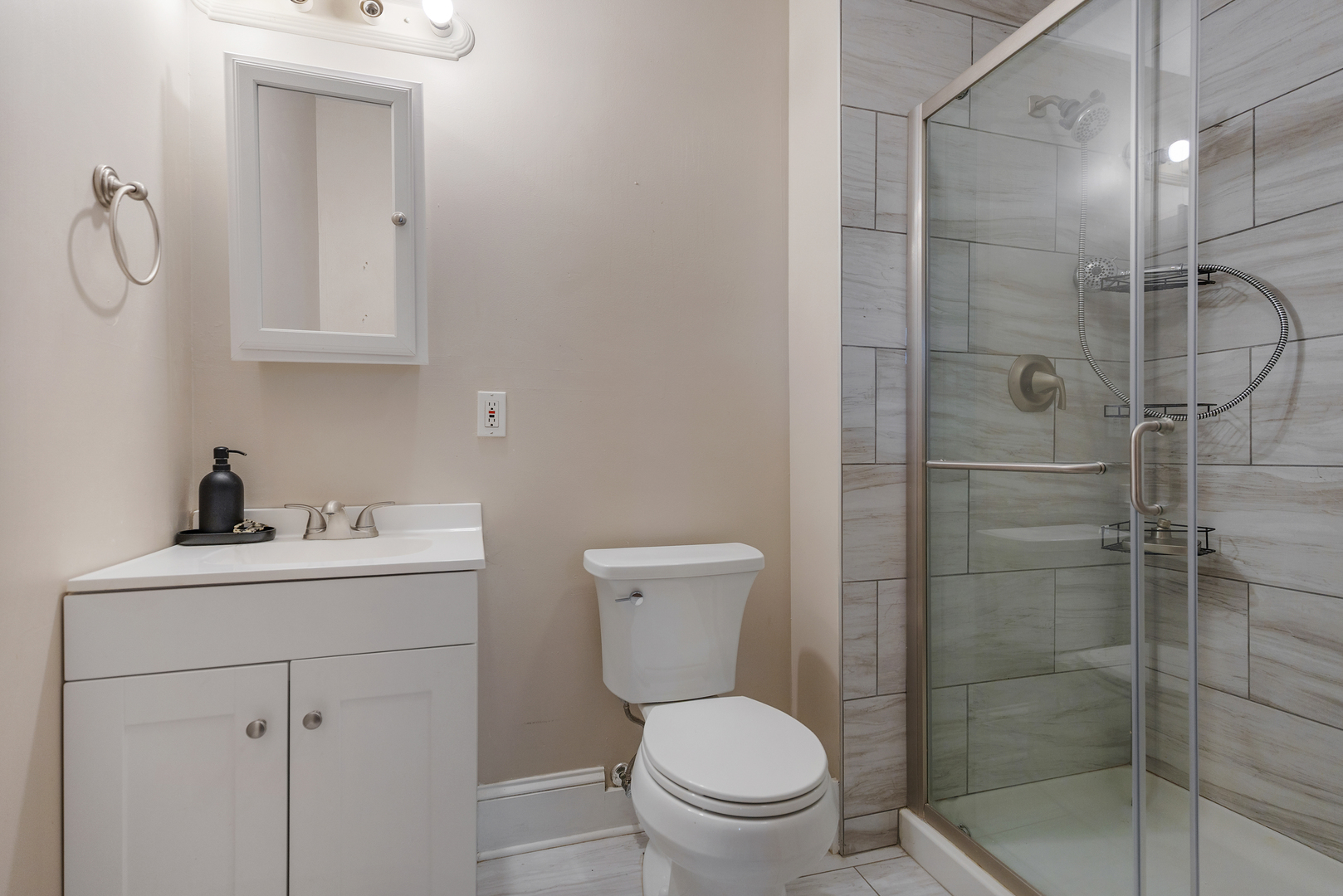 222 West Main Street, Unit A St. Charles, IL 60174 - Photo 15 of 17 a bathroom with a toilet sink vanity and shower