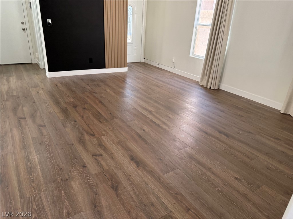 1141 Cathedral Ridge Street Henderson, NV 89052 - Photo 13 of 77 This living space features durable wood flooring and ample natural light, perfect for everyday living.