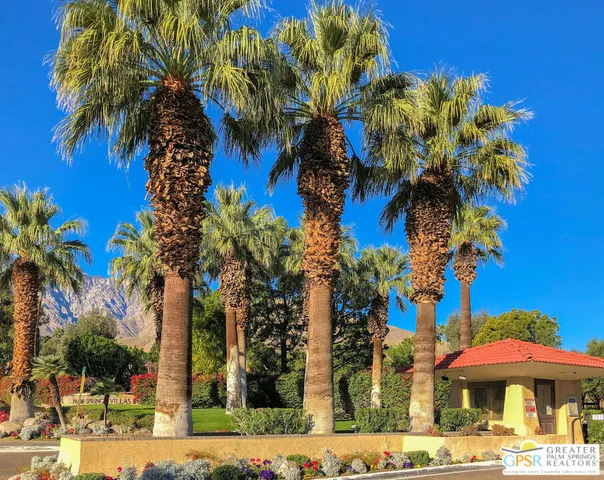 a front view of a multi story building with a yard