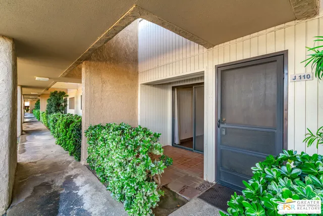 a couple of potted plants in front of door