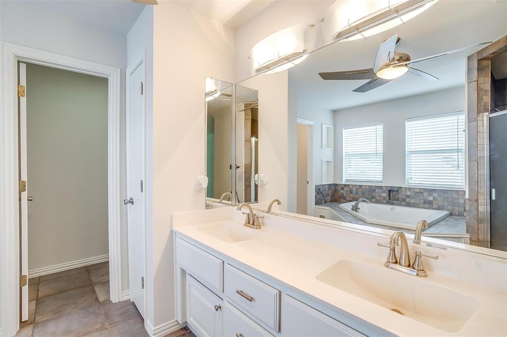 11972 Younger Court Azle, TX 76020 - Photo 21 of 40 a bathroom with double vanity sinks and a mirror