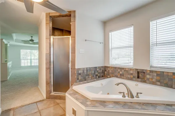 a view of kitchen with granite countertop cabinets and window