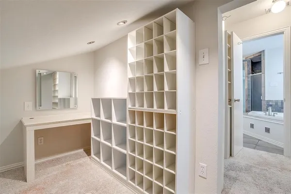 an empty room with chandelier fan
