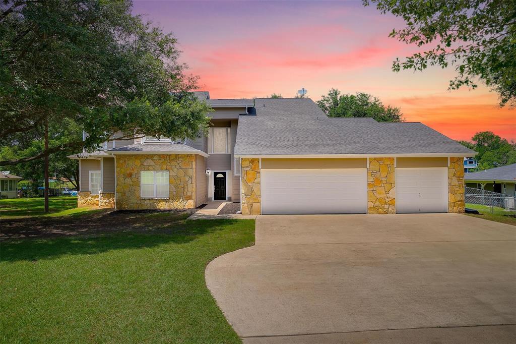 11972 Younger Court Azle, TX 76020 - Photo 6 of 40 a front view of a house with a yard and garage
