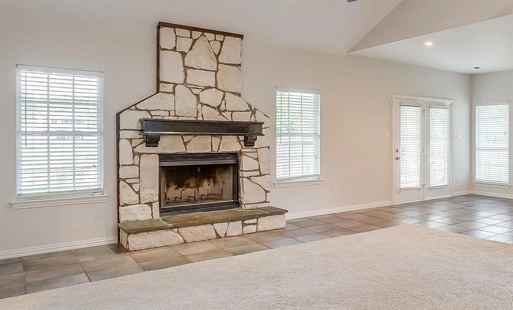11972 Younger Court Azle, TX 76020 - Photo 9 of 40 a living room with furniture a window and a fireplace