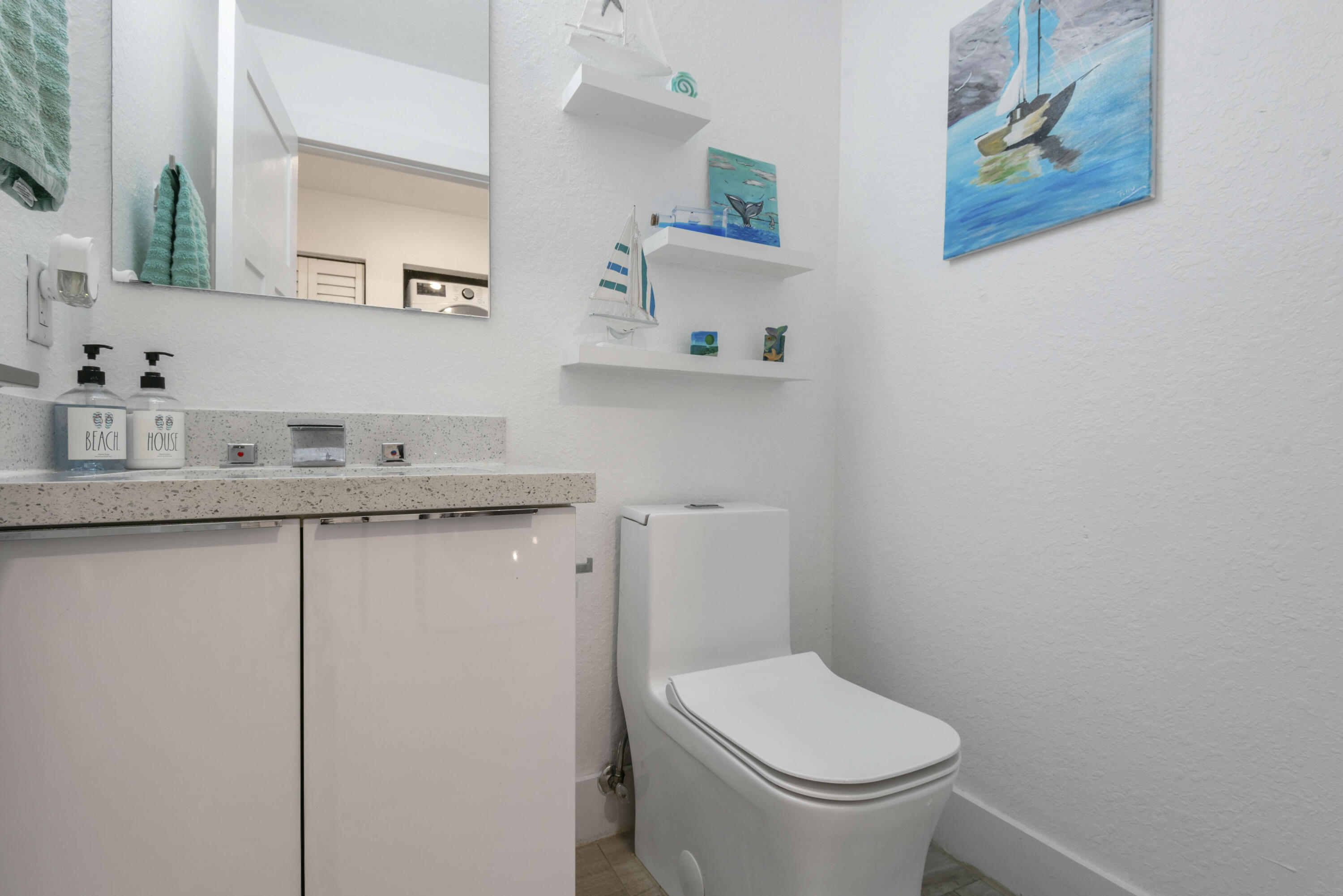 325 Calusa Street, Unit 96 Key Largo, FL 33037 - Photo 13 of 17 a bathroom with a toilet sink and mirror