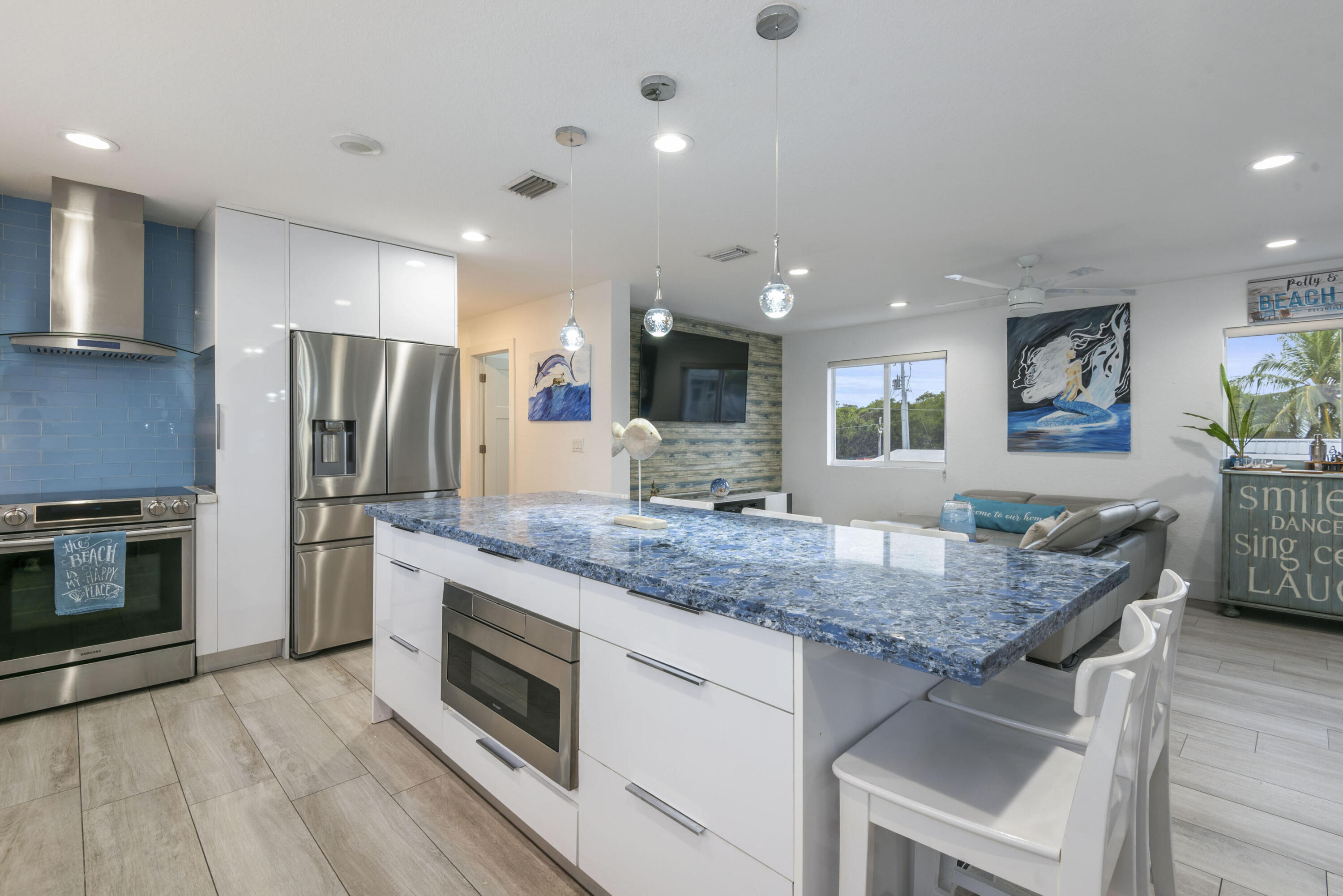 325 Calusa Street, Unit 96 Key Largo, FL 33037 - Photo 6 of 17 a kitchen with stainless steel appliances granite countertop a kitchen island hardwood floor sink stove and refrigerator