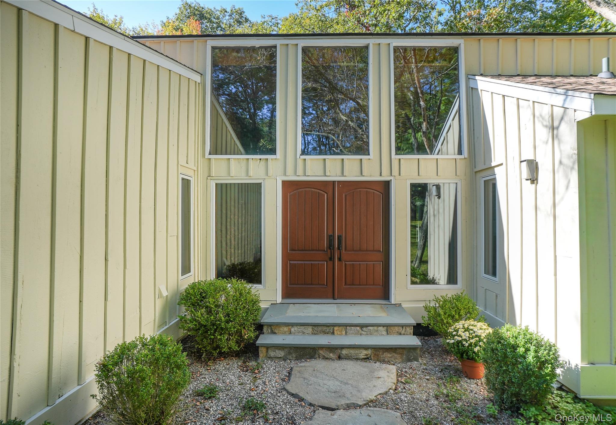 22 Peters Lane Pound Ridge, NY 10576 - Photo 3 of 43 Contemporary facade featuring vertical siding and an expansive window array