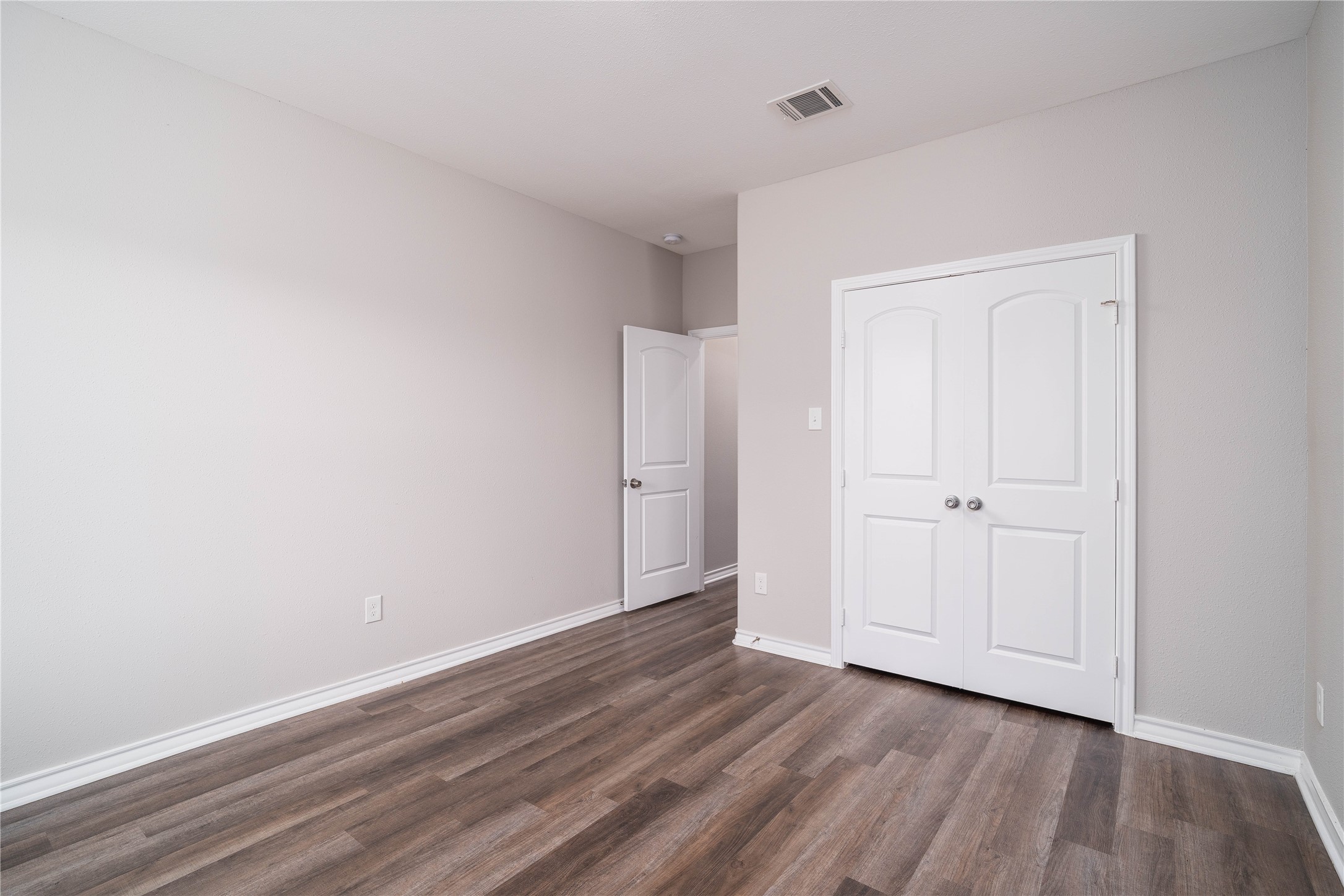 231 McCormick Street Columbus, TX 78934 - Photo 27 of 27 Bedroom – Another view of the bedroom highlighting the spacious floor plan, large closet, and easy access to adjacent living areas.