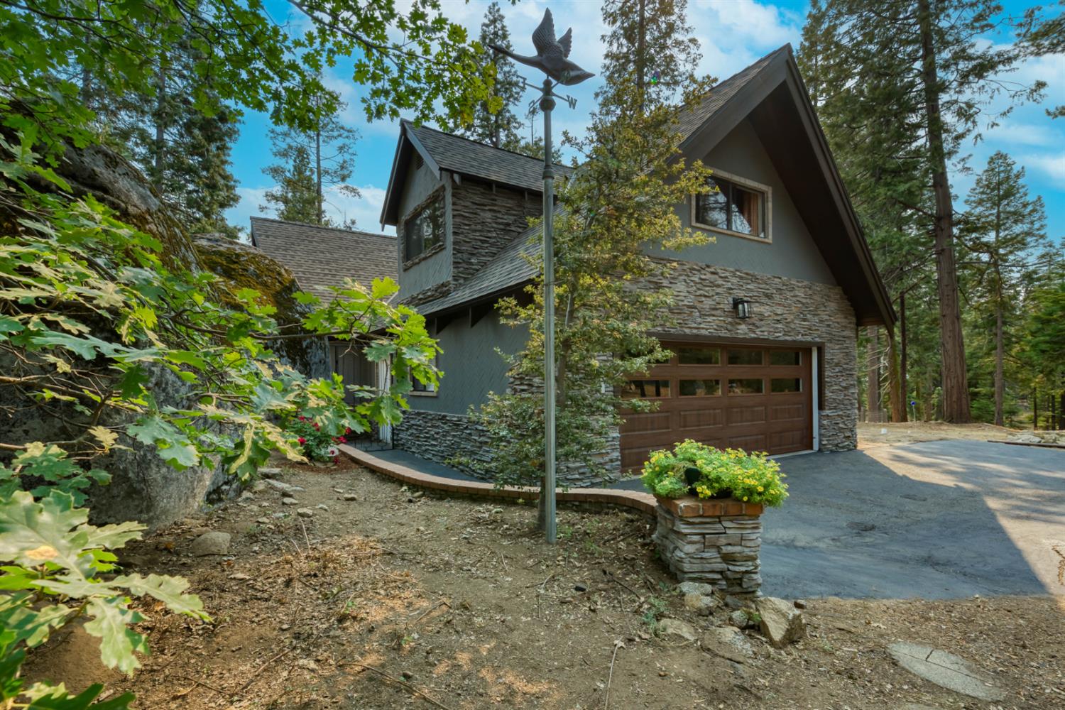 38848 Ridge Road Shaver Lake, CA 93664 - Photo 13 of 81 a front view of a house with a garden