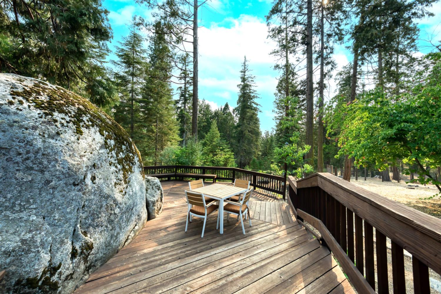 38848 Ridge Road Shaver Lake, CA 93664 - Photo 20 of 81 a roof deck with table and chairs and wooden floor