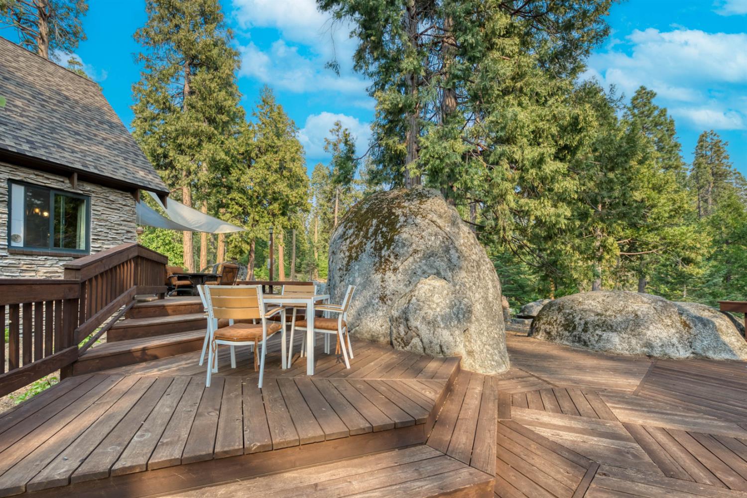 38848 Ridge Road Shaver Lake, CA 93664 - Photo 24 of 81 a view of a chairs and table on the wooden floor