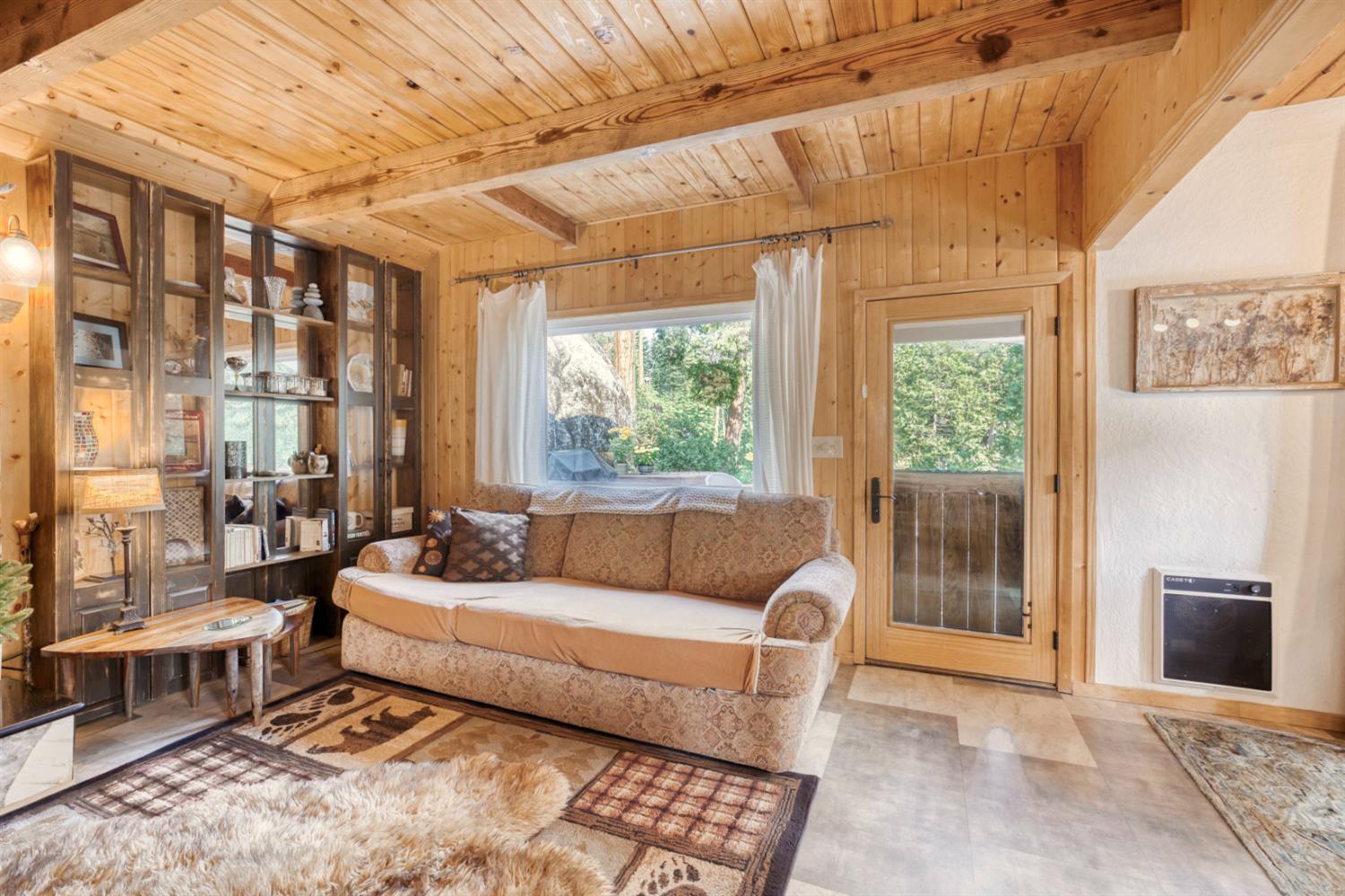 38848 Ridge Road Shaver Lake, CA 93664 - Photo 26 of 81 a living room with furniture and a floor to ceiling window