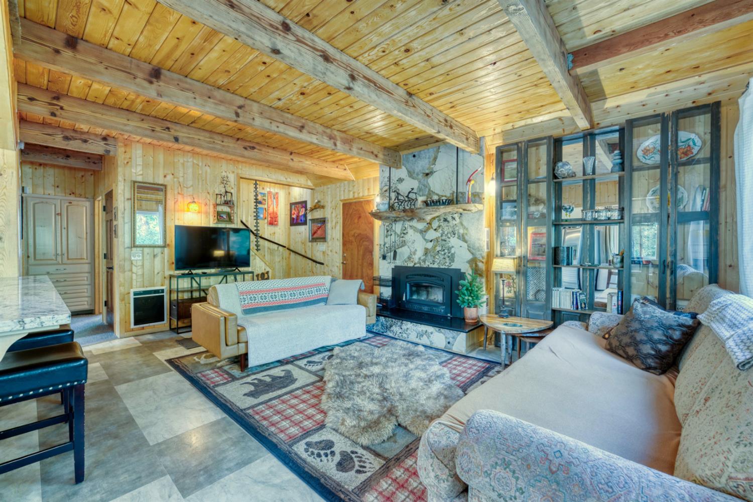 38848 Ridge Road Shaver Lake, CA 93664 - Photo 27 of 81 a living room with furniture and a fireplace