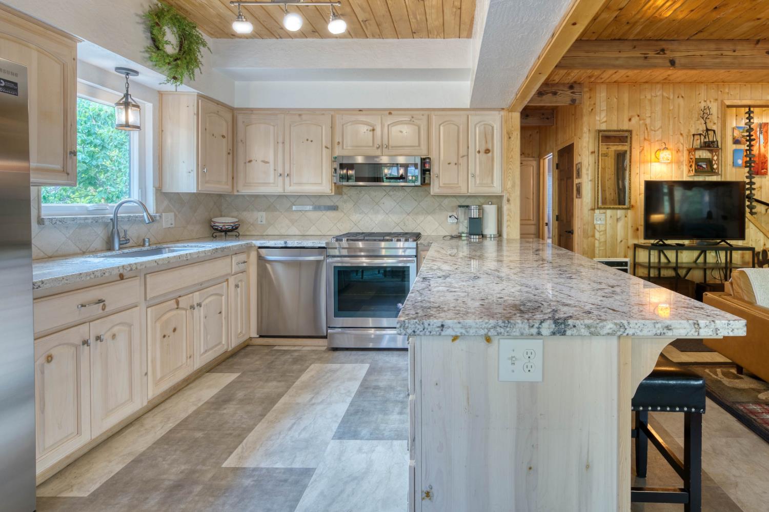 38848 Ridge Road Shaver Lake, CA 93664 - Photo 33 of 81 a kitchen with stainless steel appliances granite countertop a stove a sink and a microwave