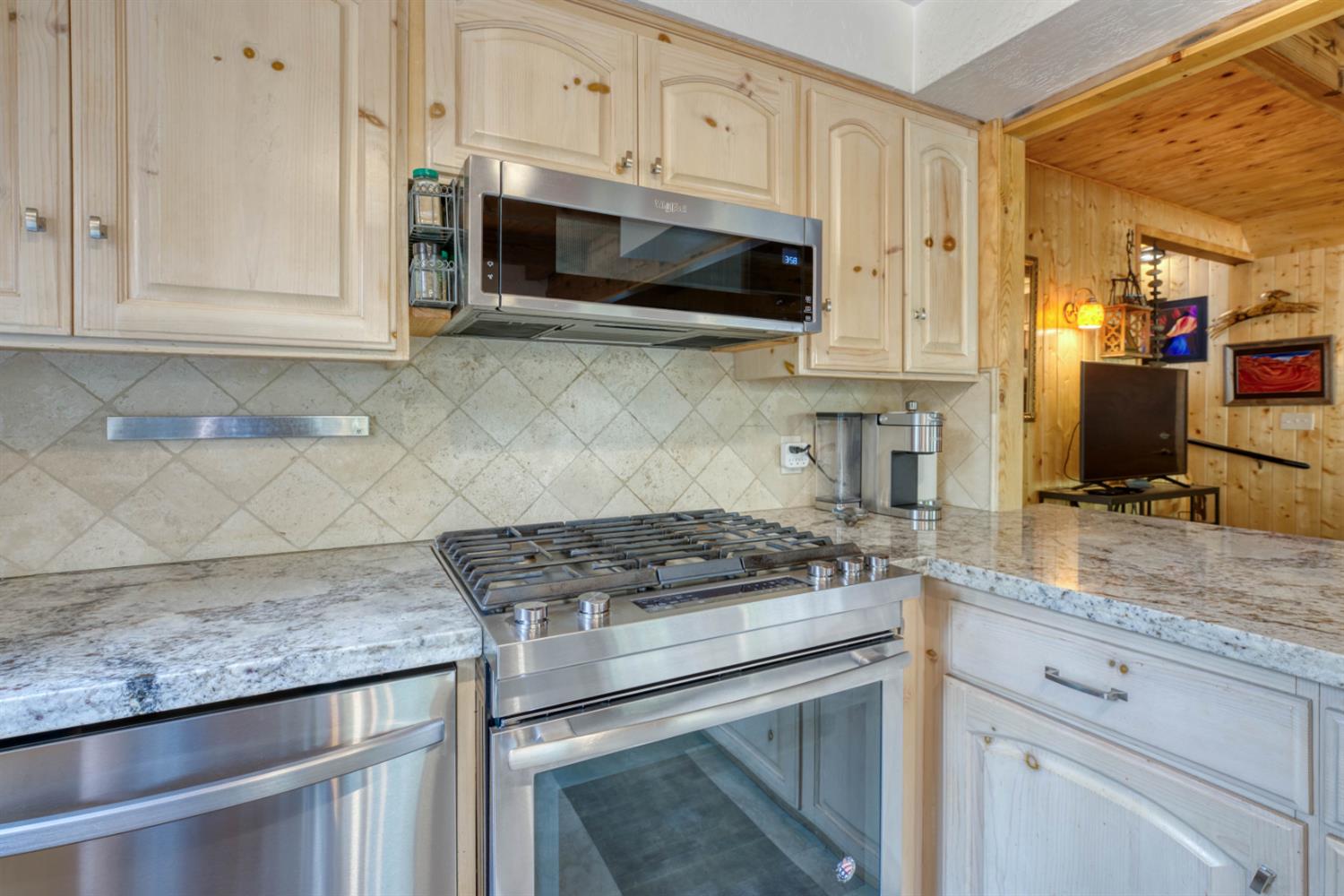 38848 Ridge Road Shaver Lake, CA 93664 - Photo 35 of 81 a kitchen with stainless steel appliances granite countertop a sink stove and microwave