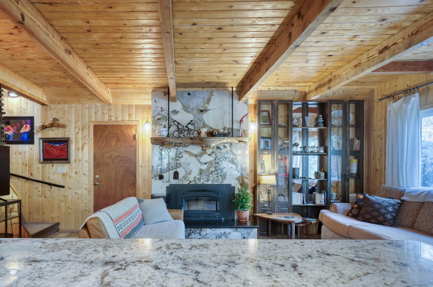 38848 Ridge Road Shaver Lake, CA 93664 - Photo 36 of 81 a living room with furniture wooden floor and a fireplace