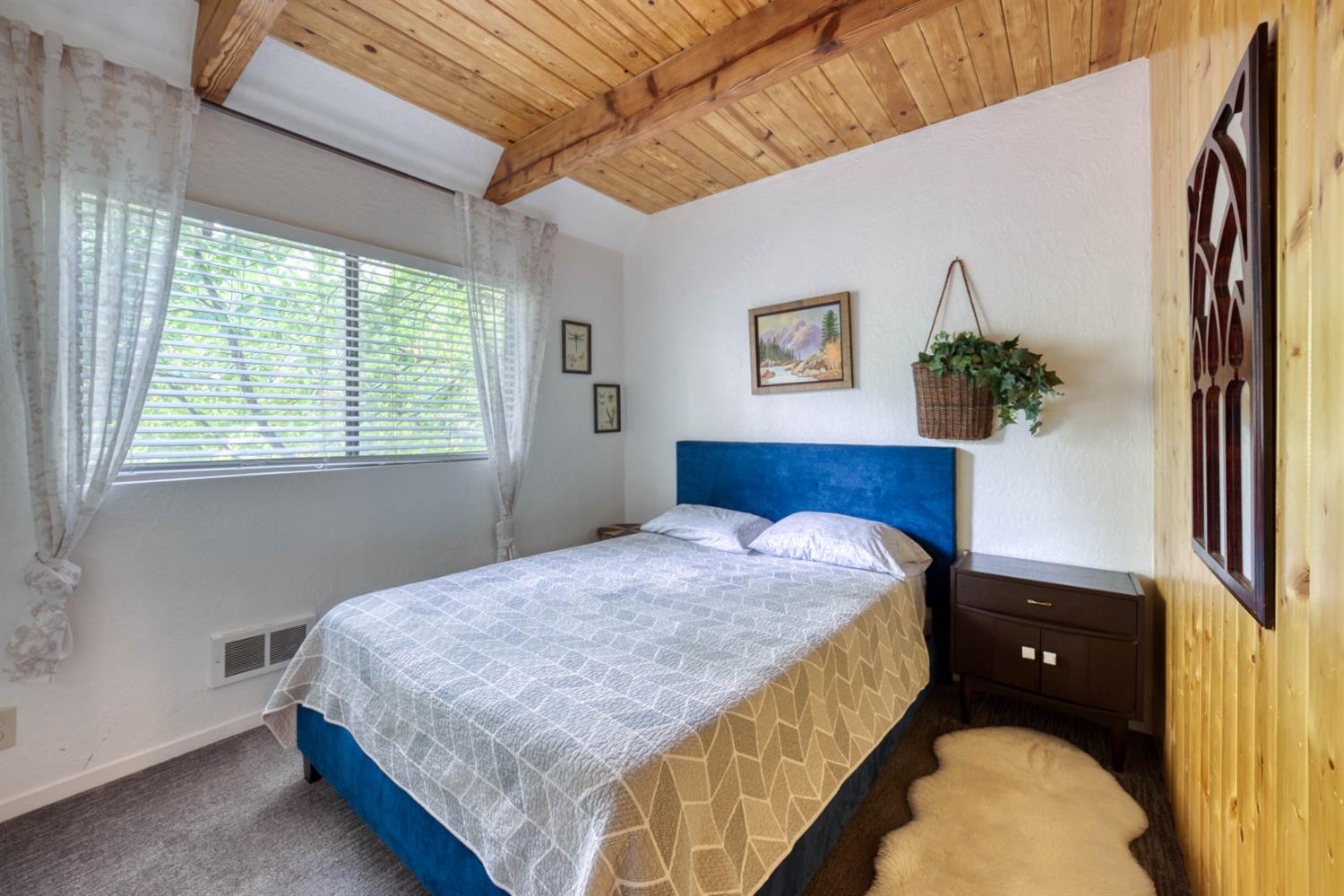 38848 Ridge Road Shaver Lake, CA 93664 - Photo 40 of 81 a bedroom with a bed and a potted plant