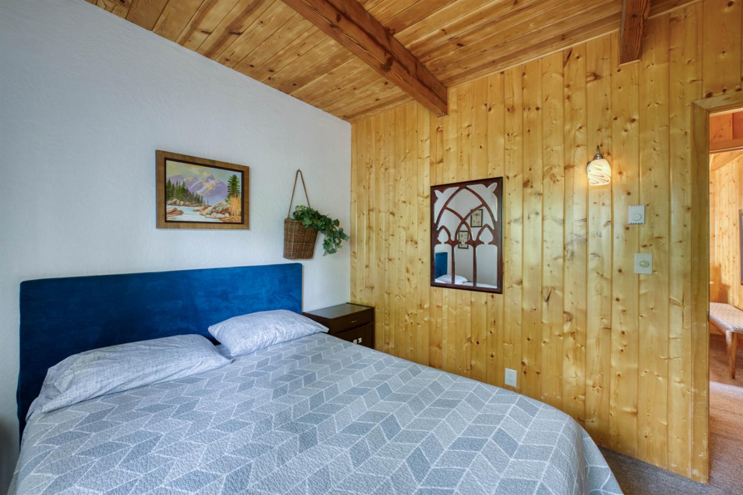 38848 Ridge Road Shaver Lake, CA 93664 - Photo 41 of 81 a bedroom with a bed and wall painting