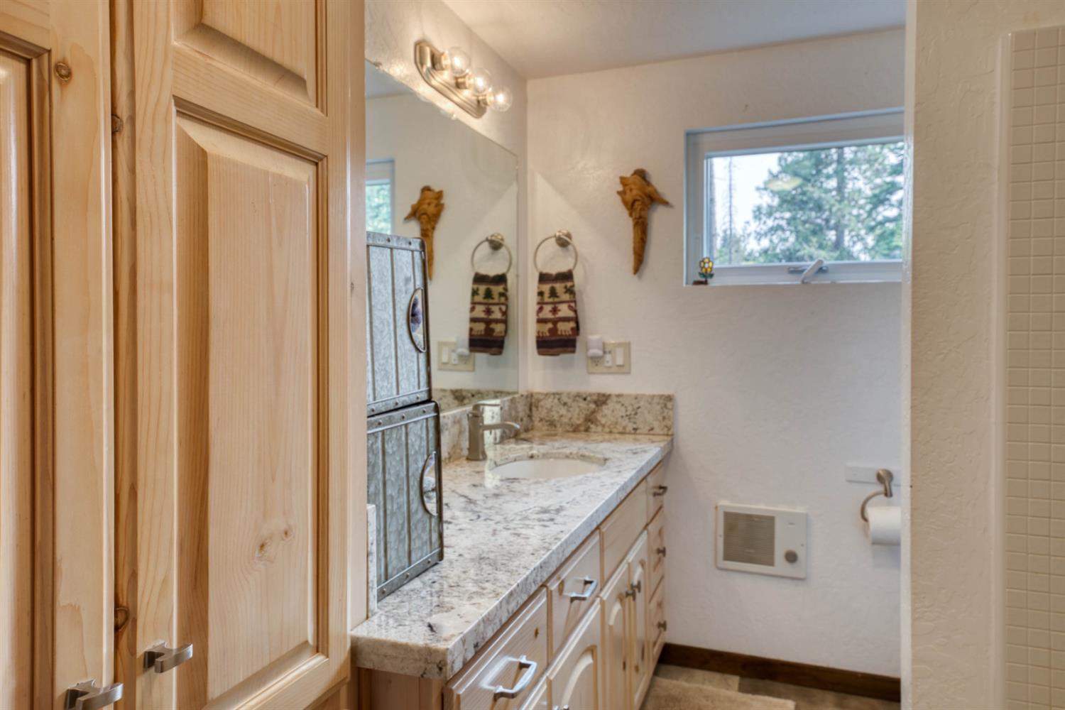 38848 Ridge Road Shaver Lake, CA 93664 - Photo 44 of 81 a bathroom with a granite countertop sink and a mirror