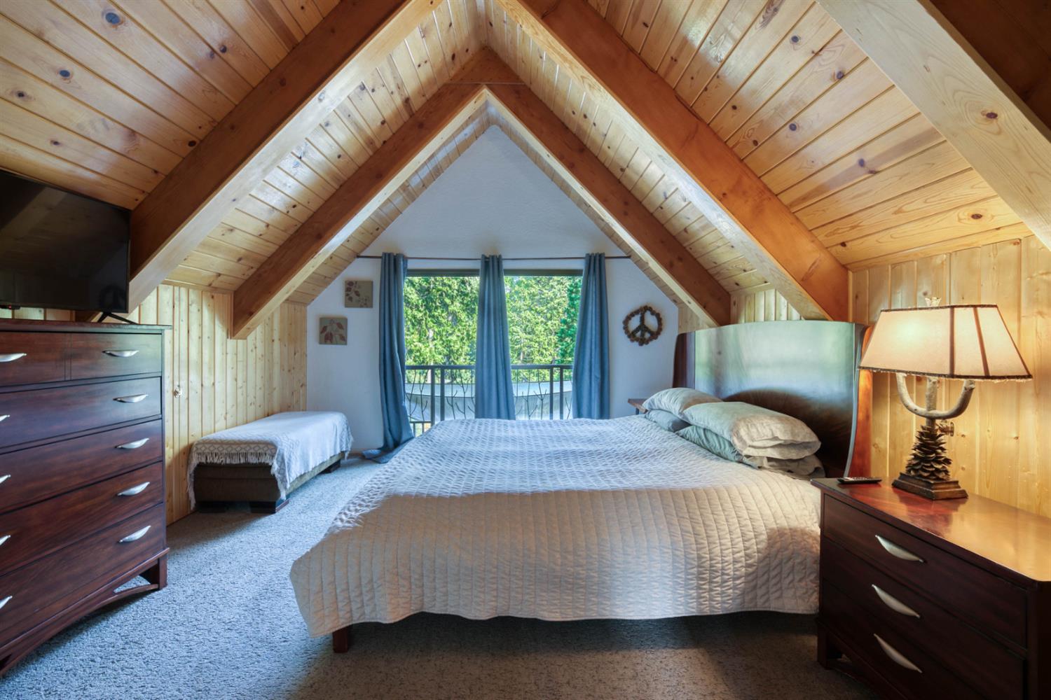 38848 Ridge Road Shaver Lake, CA 93664 - Photo 45 of 81 a bedroom with a bed lamp and a large window