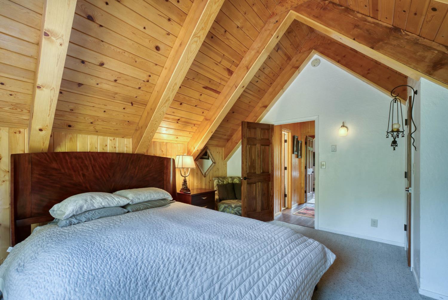 38848 Ridge Road Shaver Lake, CA 93664 - Photo 46 of 81 a bedroom with a bed and a mirror