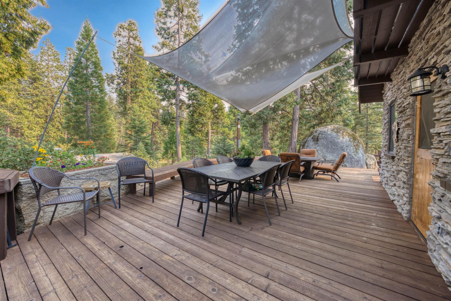 38848 Ridge Road Shaver Lake, CA 93664 - Photo 59 of 81 a view of a patio with table and chairs and wooden floor