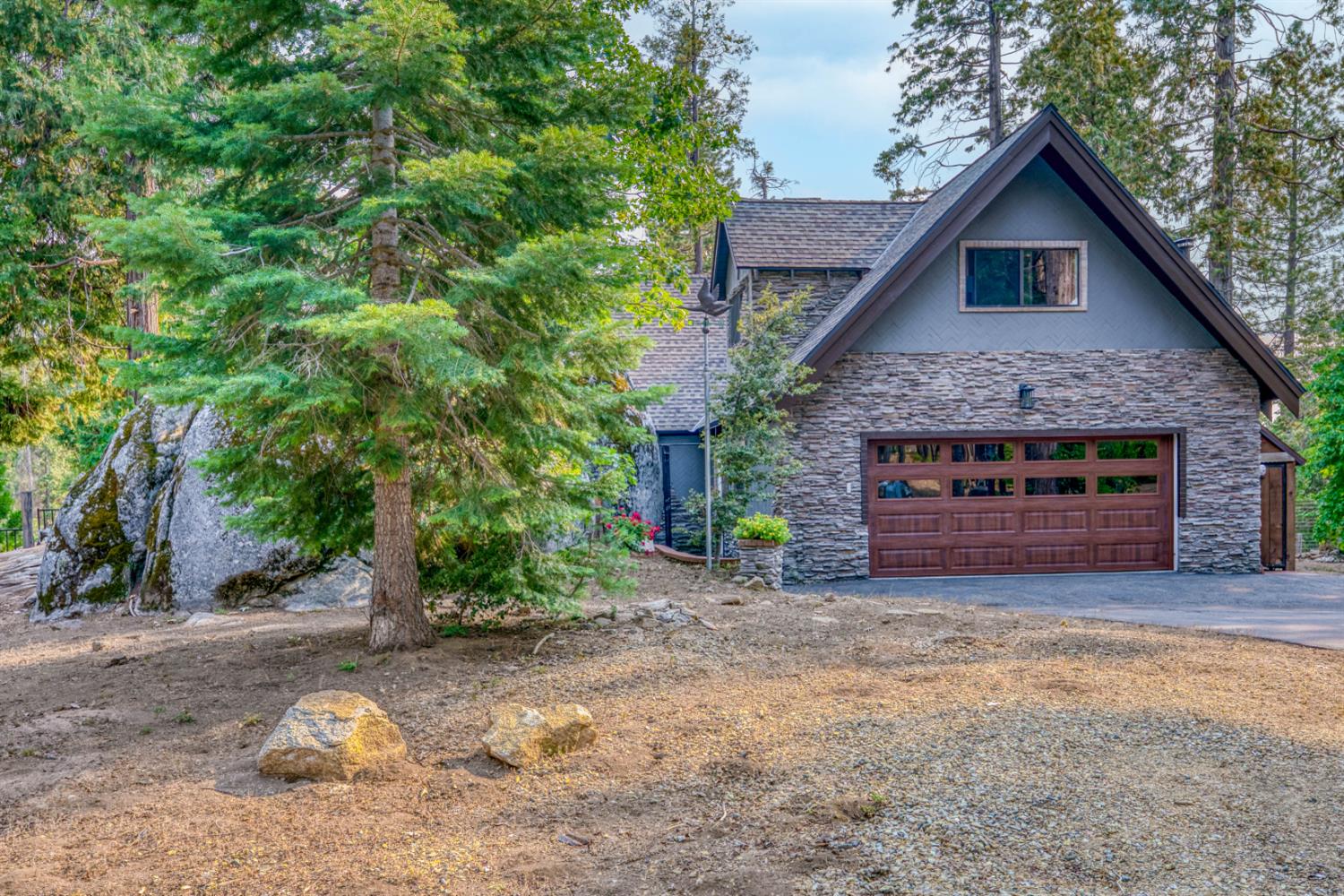 38848 Ridge Road Shaver Lake, CA 93664 - Photo 60 of 81 a front view of a house with a yard and garage