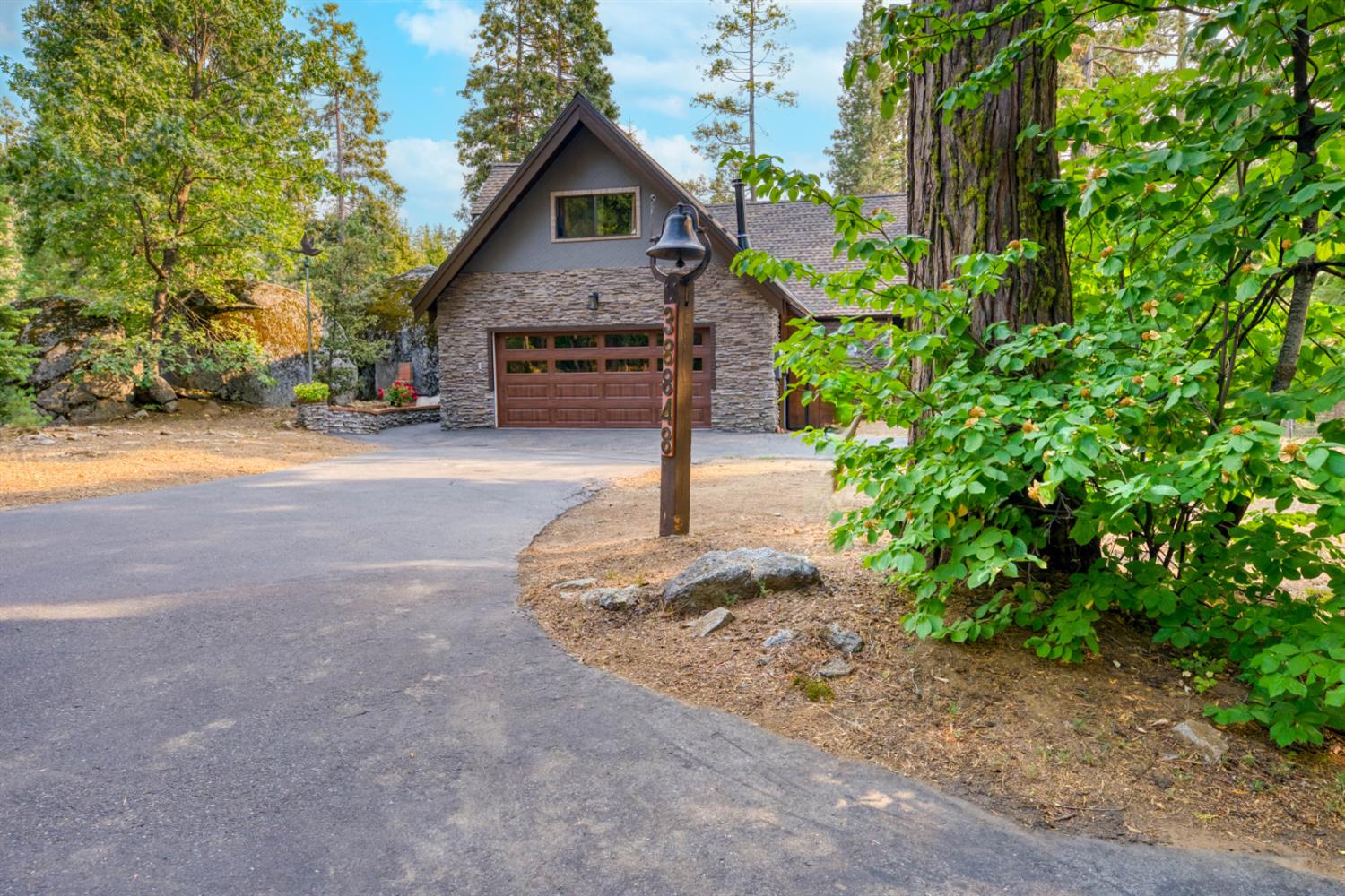 38848 Ridge Road Shaver Lake, CA 93664 - Photo 64 of 81 a front view of a house with a yard and garage