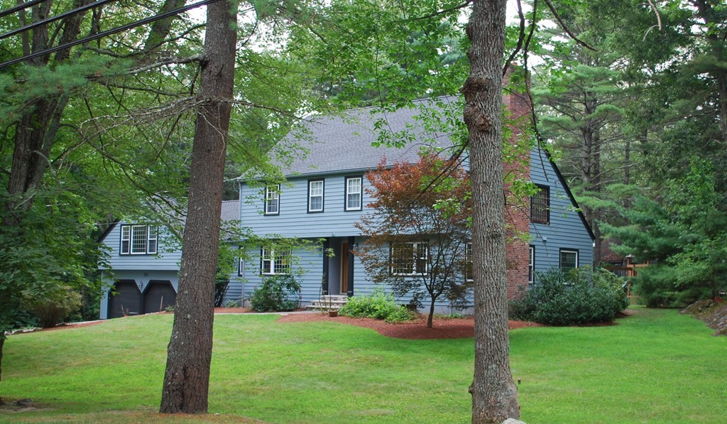 68 Herrick Road Boxford, MA 01921 - Photo 1 of 25 a front view of a house with a yard and trees
