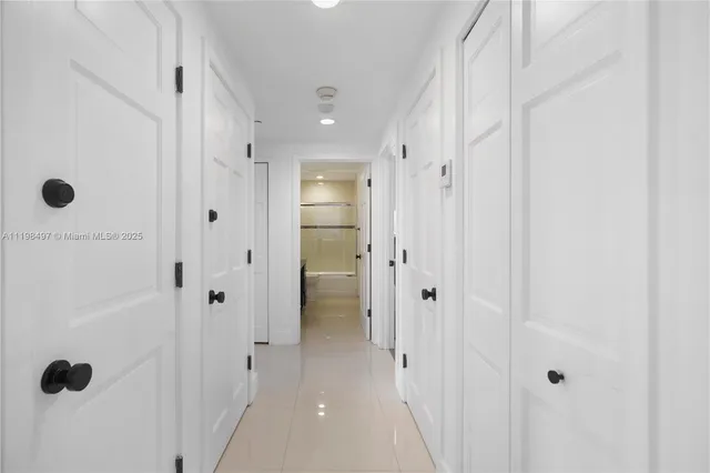 a bedroom with two beds and a large window