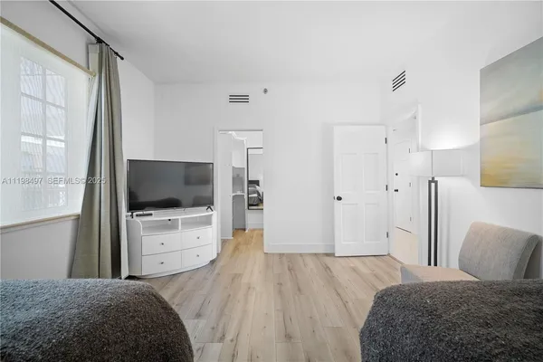a bedroom with a bed and a flat screen tv