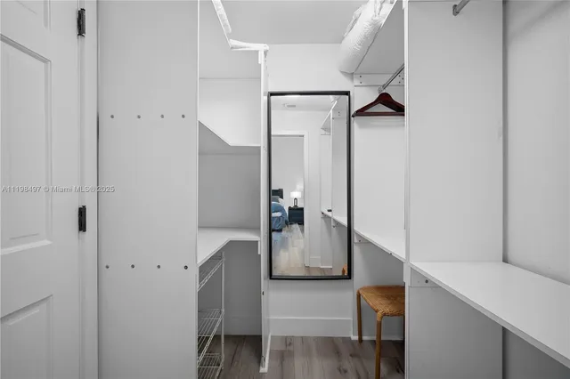 a bathroom with a granite countertop sink a mirror and shower